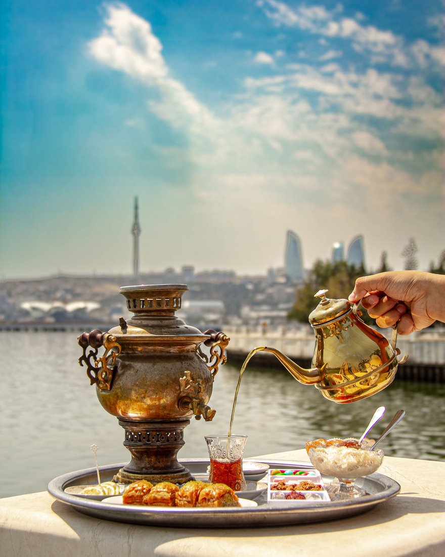Tea and sweets served above the Caspian, with Baku's Flame Towers beyond