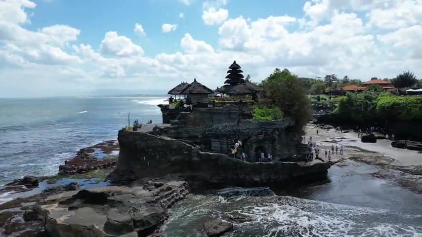 The Tanah Lot temple perched on its rocky sea cliff in Bali