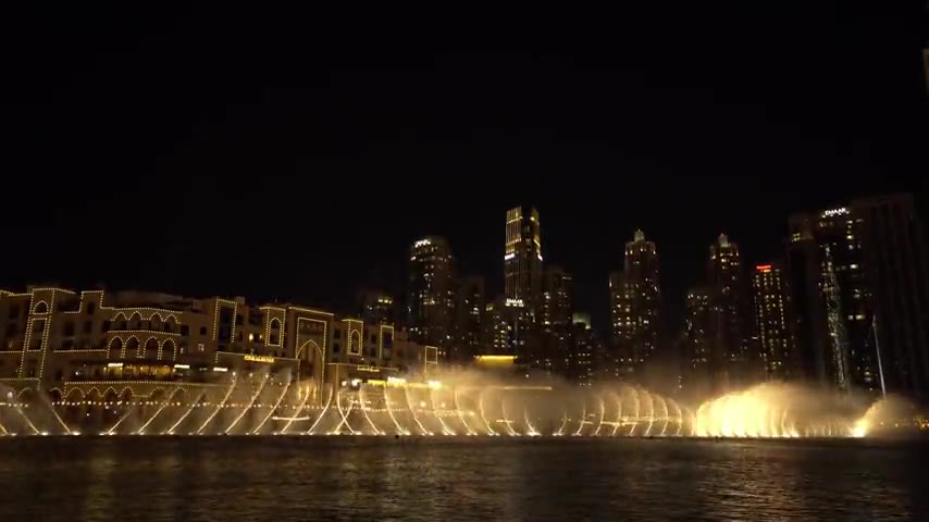 Dubai's Burj Khalifa Lake fountains dancing with colored lights at night