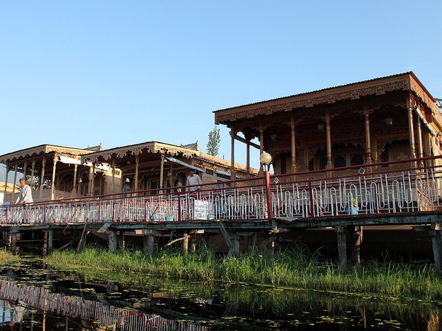 Carved wooden houseboats moored on Dal Lake in Srinagar