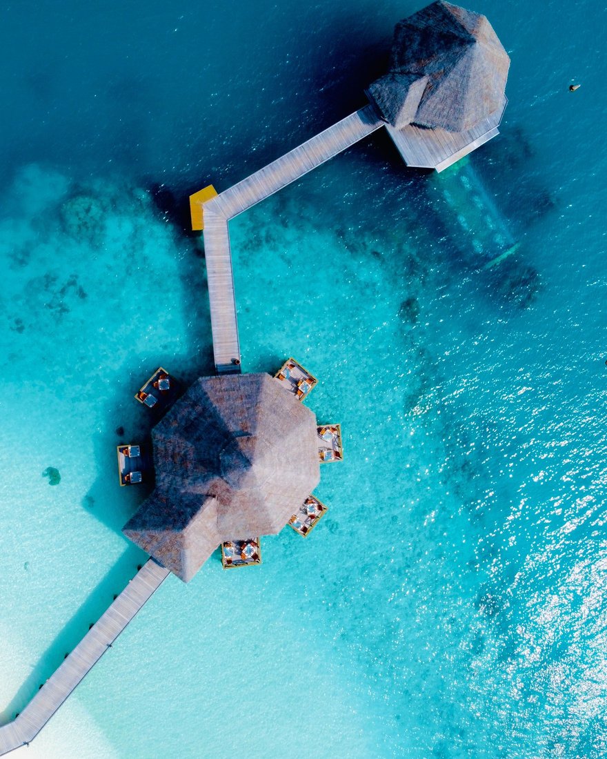 Overwater villas above a turquoise reef in the Maldives
